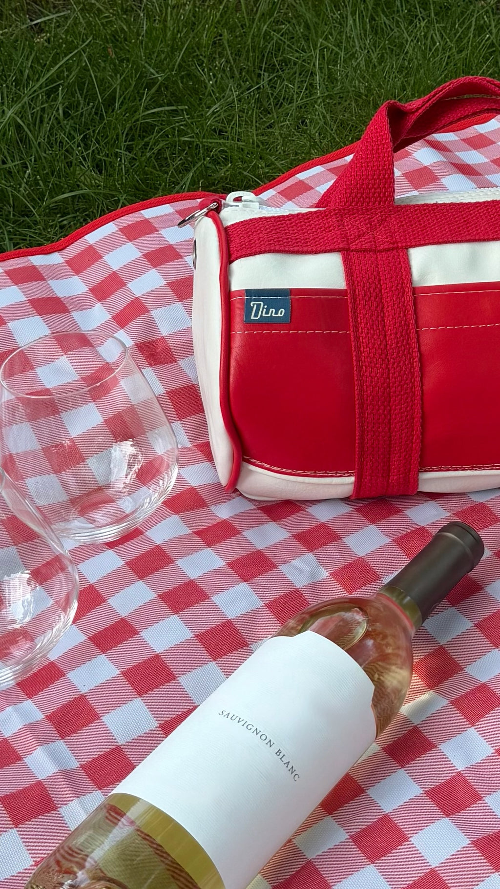 Parkside barrel duffel on gingham blanket with Sauvignon Blanc and wine glass